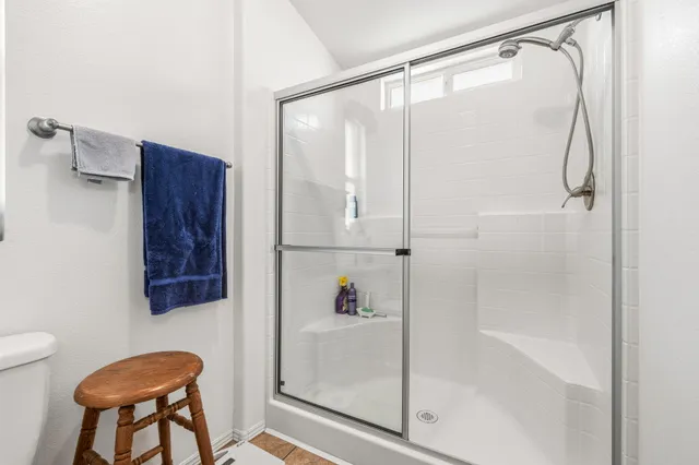 a bathroom with a shower and a sink
