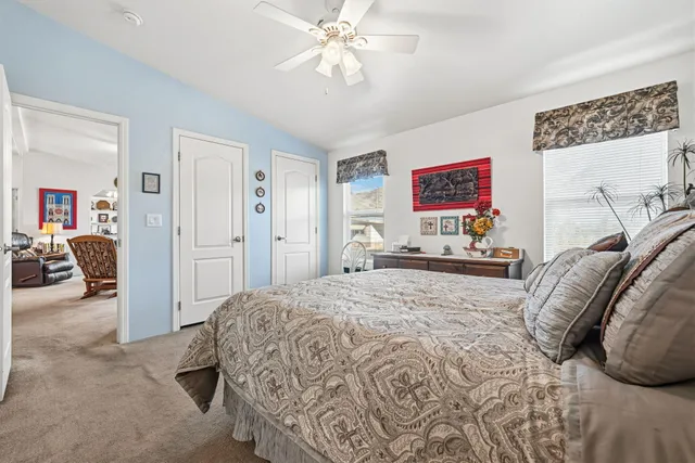 a bedroom with a bed and a chandelier