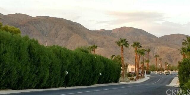 74711 Dillon Road, Unit 312 Desert Hot Springs, CA 92241 - Photo 36 of 49 a view of a street with a mountain in the background