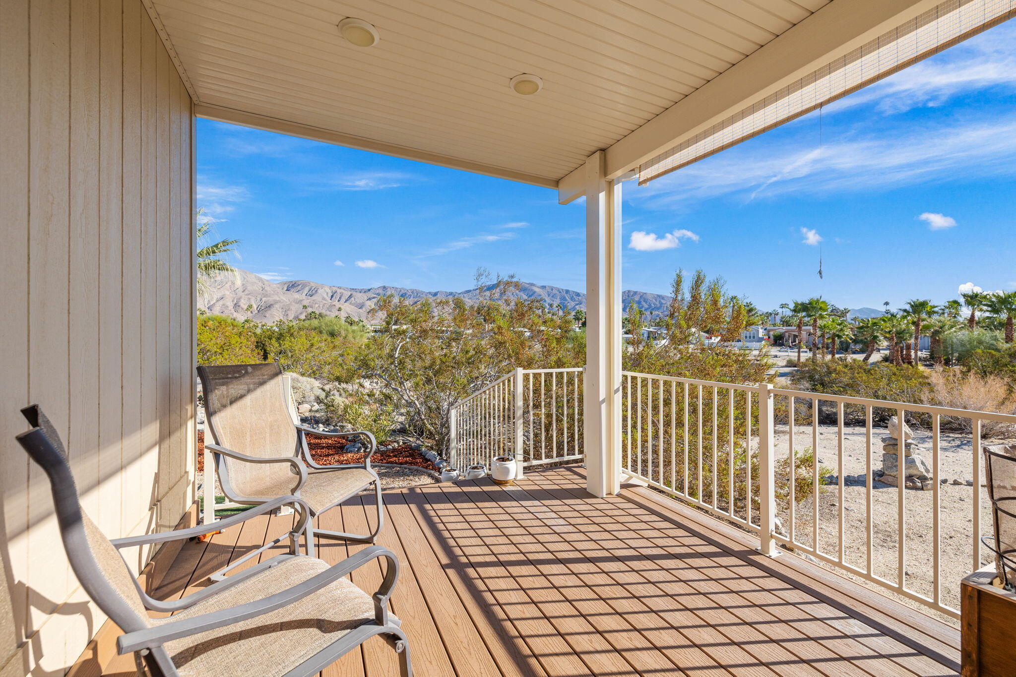 74711 Dillon Road, Unit 312 Desert Hot Springs, CA 92241 - Photo 5 of 49 a view of a balcony with chairs and wooden floor