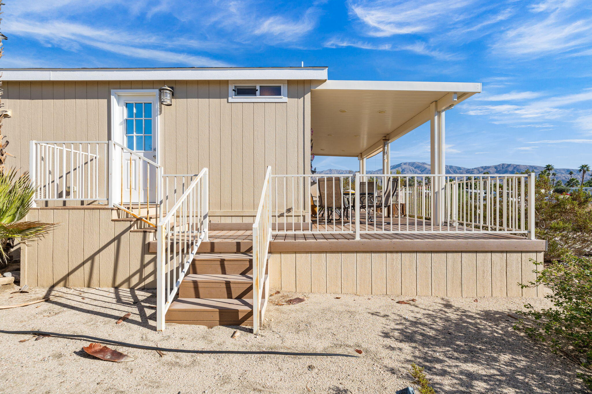 74711 Dillon Road, Unit 312 Desert Hot Springs, CA 92241 - Photo 8 of 49 a view of a balcony with wooden floor and fence