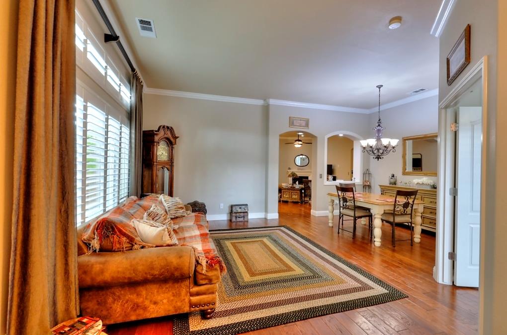4152 Post Oak Drive Turlock, CA 95382 - Photo 12 of 71 a living room with furniture a dining table and a chandelier