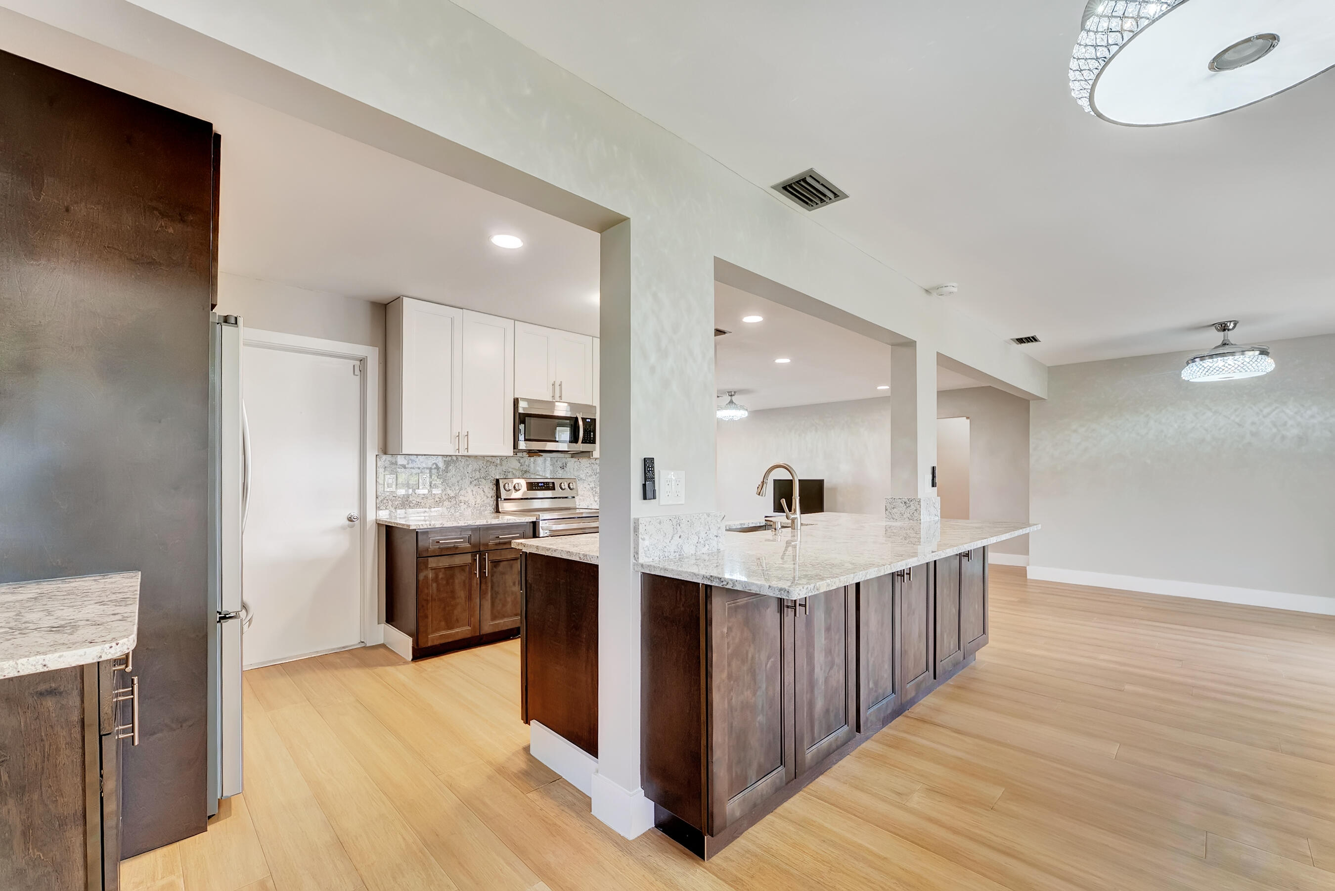 14263 El Clavel Way Delray Beach, FL 33484 - Photo 17 of 39 a kitchen with stainless steel appliances kitchen island a sink stove and cabinets