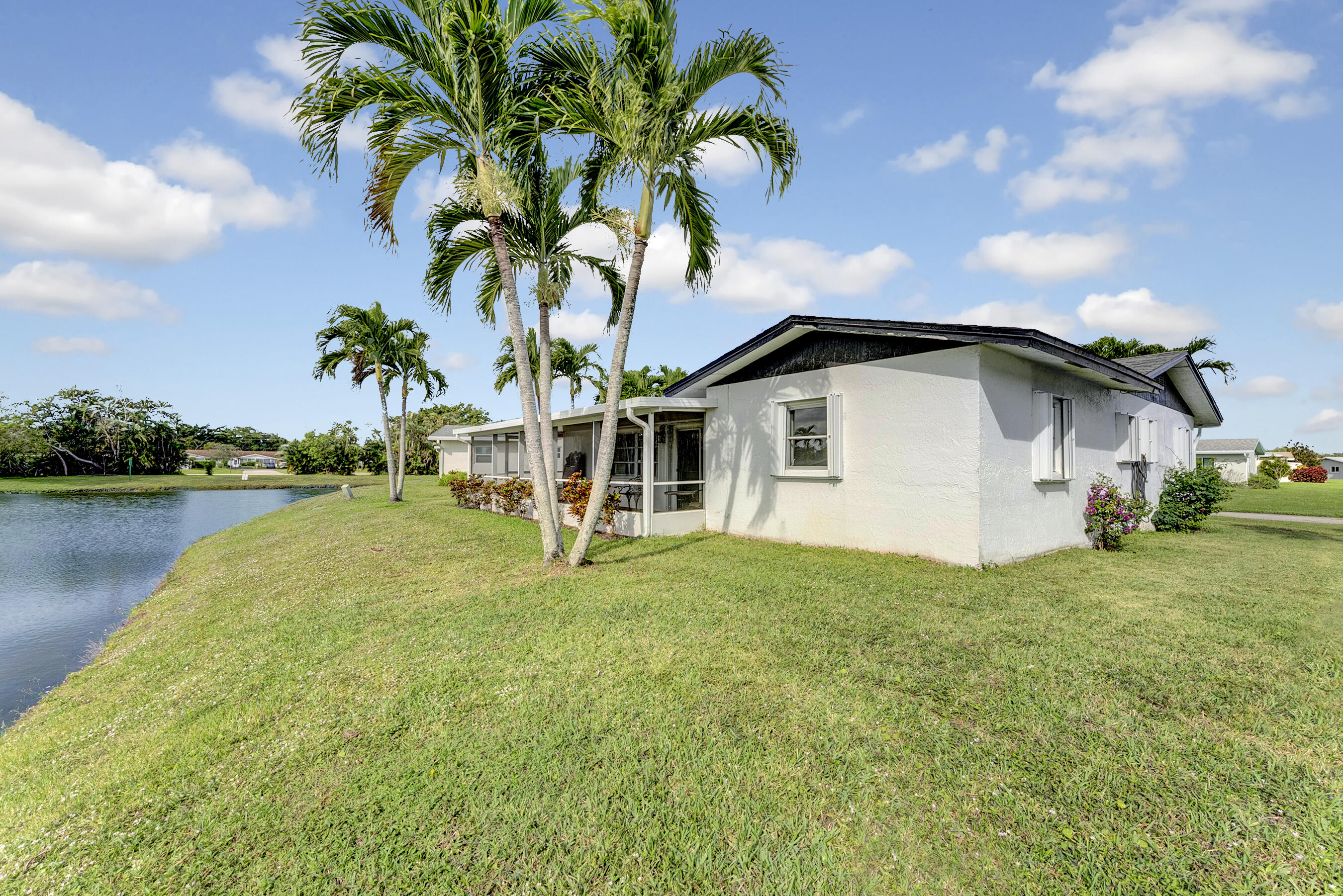 14263 El Clavel Way Delray Beach, FL 33484 - Photo 2 of 39 a view of a backyard with plants and lake view