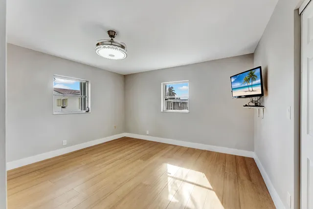 a bathroom with a granite countertop toilet a sink and a mirror