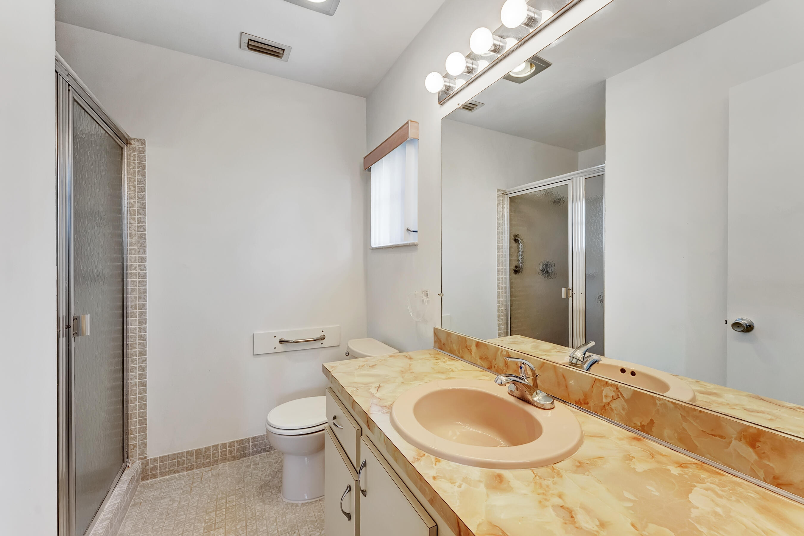 14263 El Clavel Way Delray Beach, FL 33484 - Photo 28 of 39 a bathroom with a granite countertop toilet a sink and a mirror