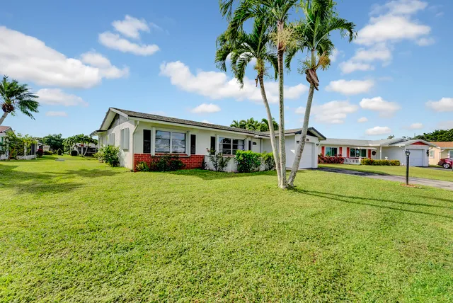 a view of house with outdoor space and swimming pool