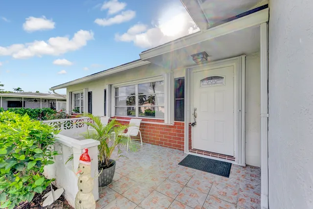 a front view of house with outdoor seating