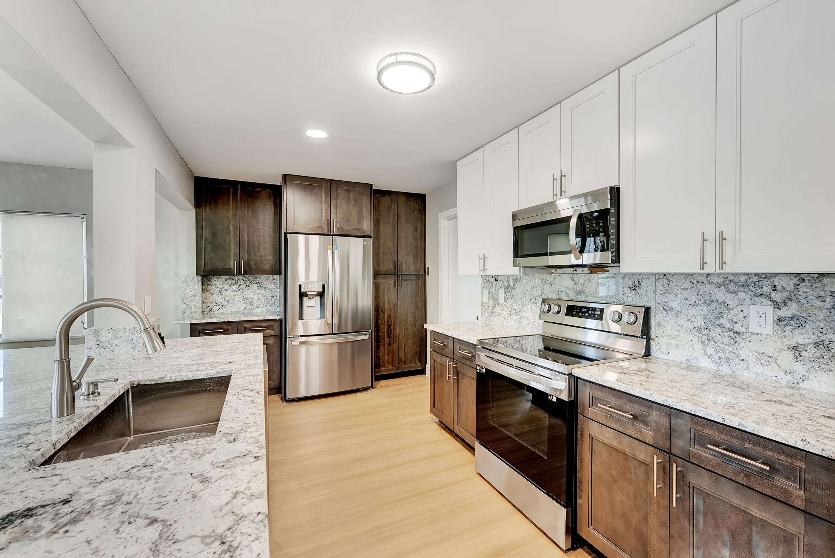14263 El Clavel Way Delray Beach, FL 33484 - Photo 7 of 39 a kitchen with stainless steel appliances granite countertop a stove a sink dishwasher a refrigerator and a microwave