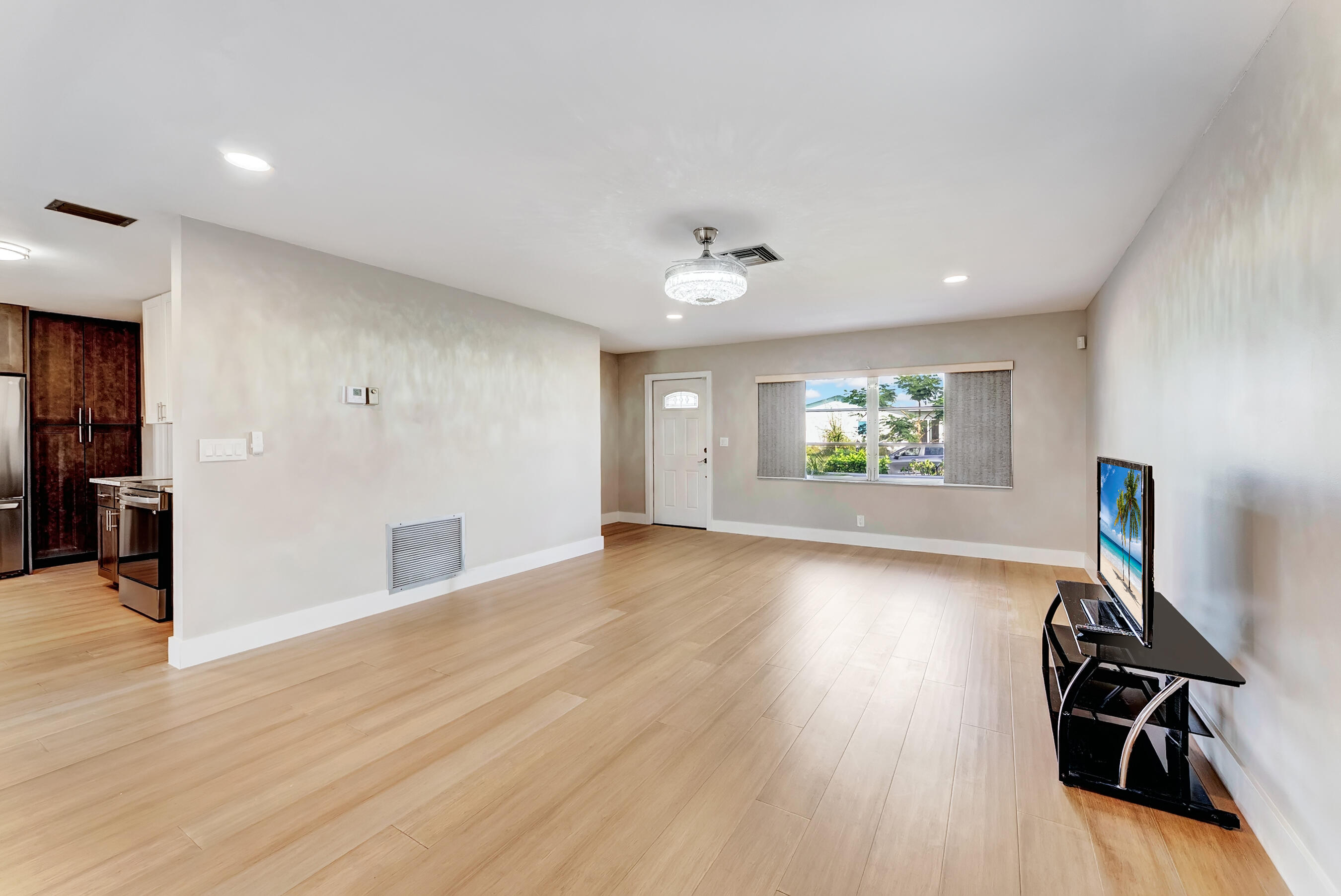 14263 El Clavel Way Delray Beach, FL 33484 - Photo 8 of 39 a view of an empty room with wooden floor and a window