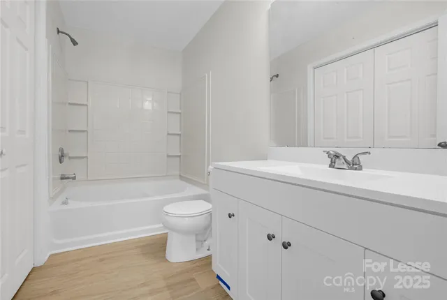 a bathroom with a sink a toilet and bathtub