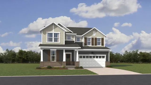 a front view of a house with a garden and trees