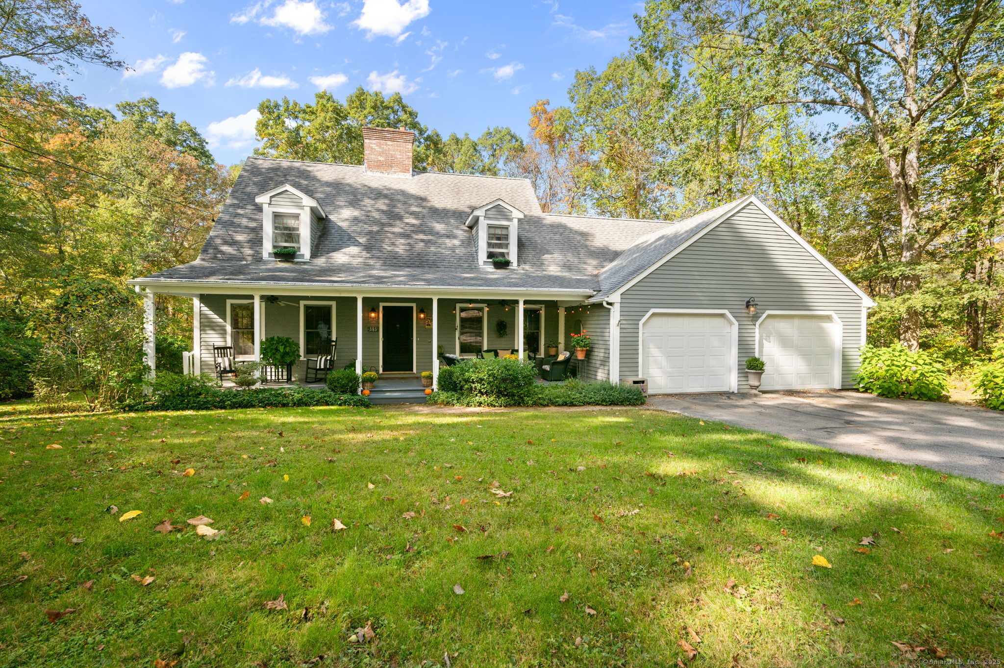 a front view of a house with a garden and porch