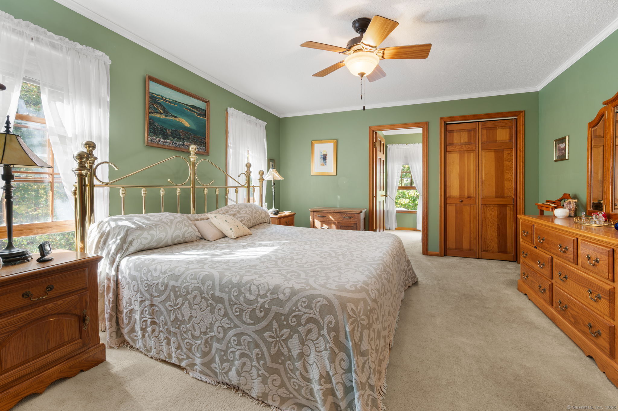 383 Lathrop Road Plainfield, CT 06374 - Photo 26 of 40 a spacious bedroom with a large bed and a chandelier