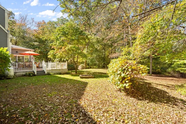a patio with wooden floor and yard