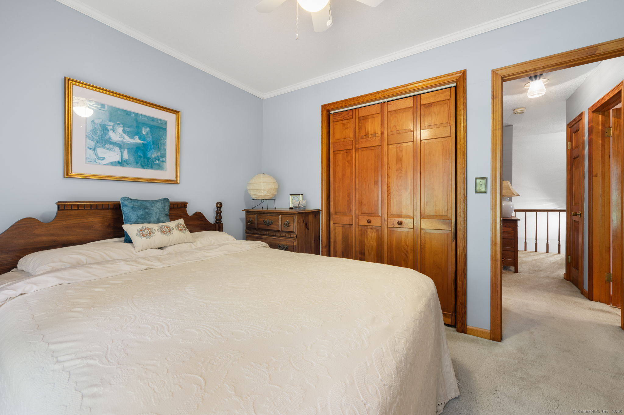 383 Lathrop Road Plainfield, CT 06374 - Photo 32 of 40 a bedroom with a large bed and a chandelier