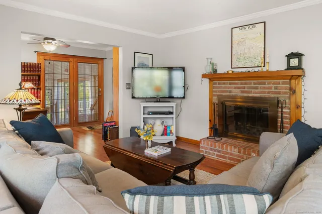 a living room with furniture fireplace and flat screen tv