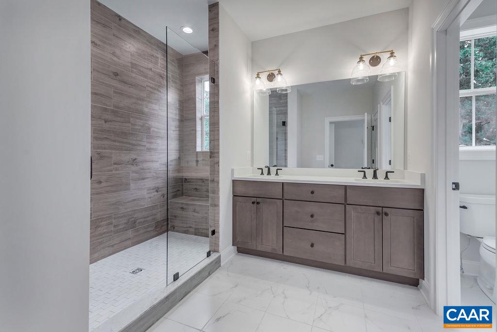 3 Rothwell Lane, Unit LOT 3 Crozet, VA 22932 - Photo 11 of 33 a bathroom with a double vanity sink mirror and shower