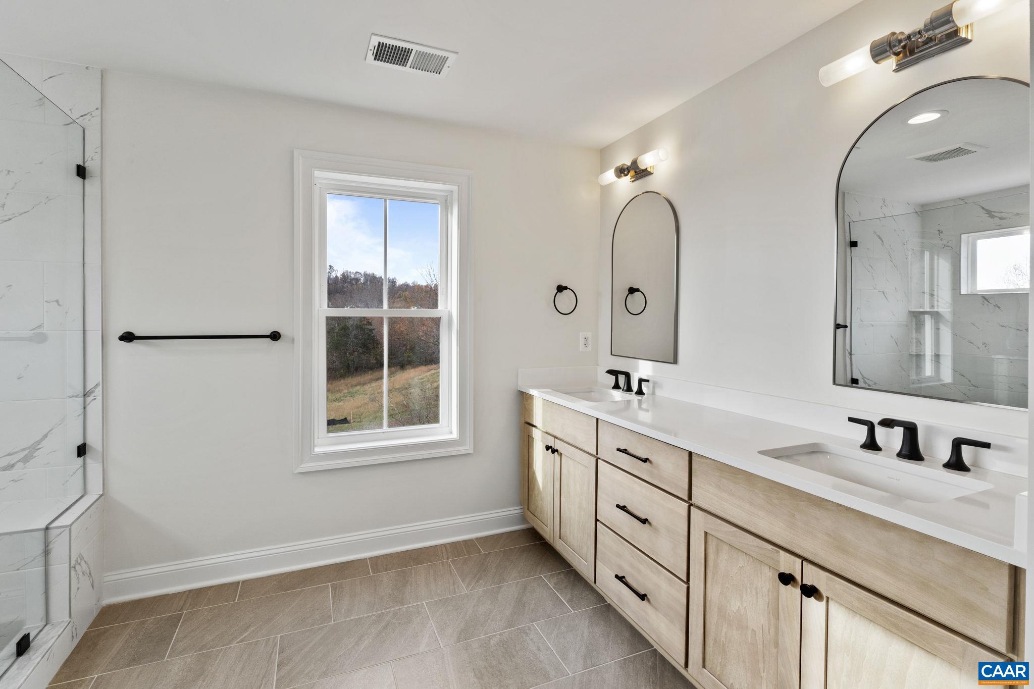3 Rothwell Lane, Unit LOT 3 Crozet, VA 22932 - Photo 12 of 33 a bathroom with a double vanity sink and a window