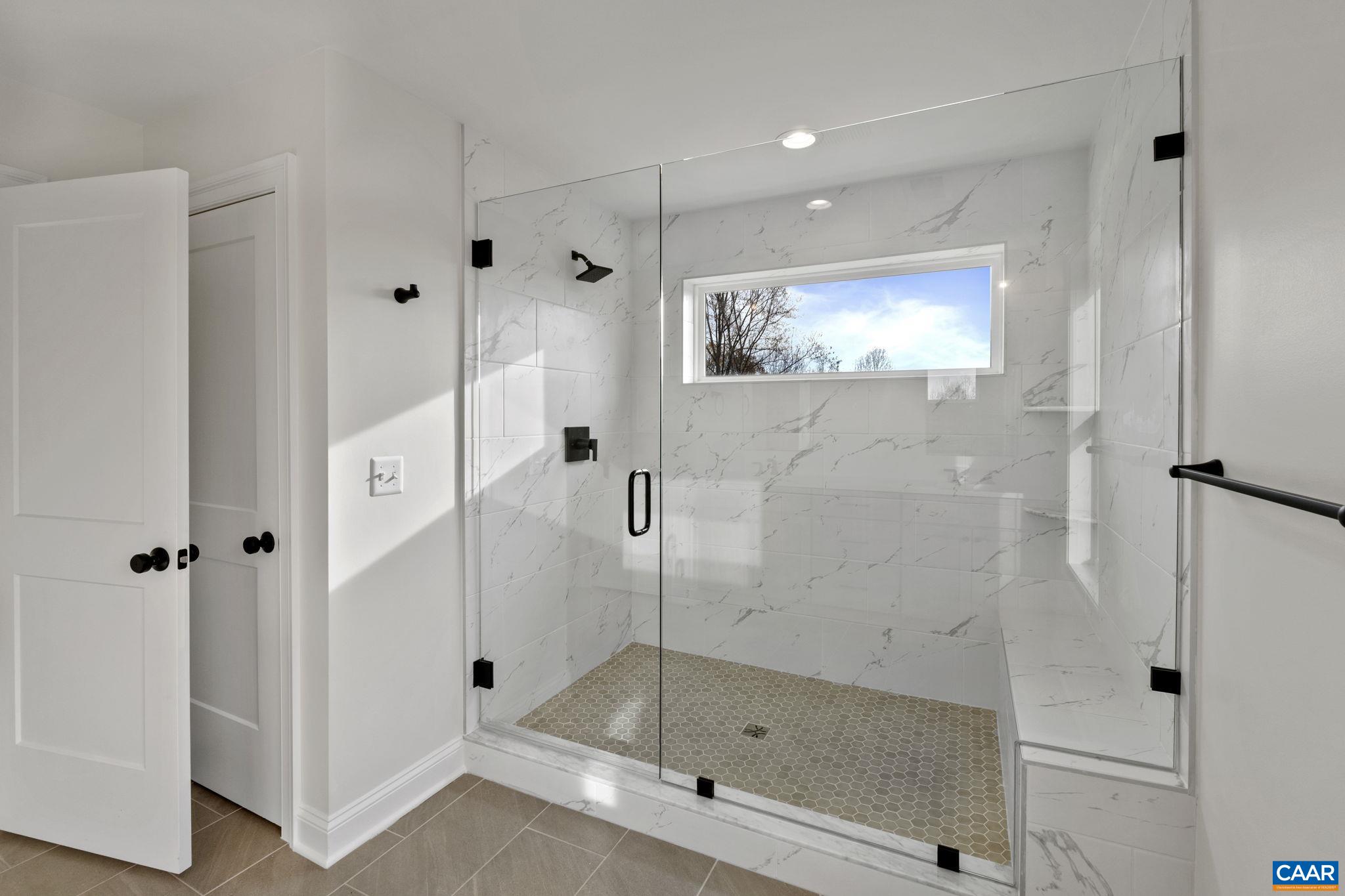 3 Rothwell Lane, Unit LOT 3 Crozet, VA 22932 - Photo 23 of 33 a bathroom with a glass shower door