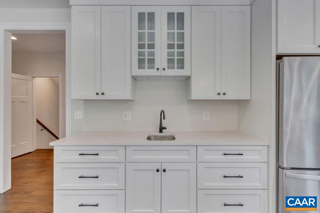 3 Rothwell Lane, Unit LOT 3 Crozet, VA 22932 - Photo 4 of 33 a kitchen with white cabinets and a refrigerator