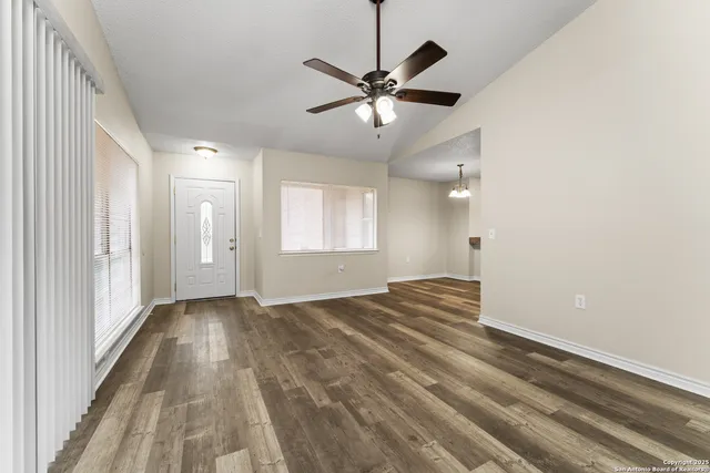 wooden floor in an empty room with a window