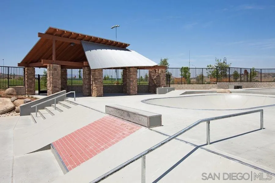 24384 Crooked Trail Menifee, CA 92584 - Photo 20 of 21 a view of a patio with a table and chairs under an umbrella