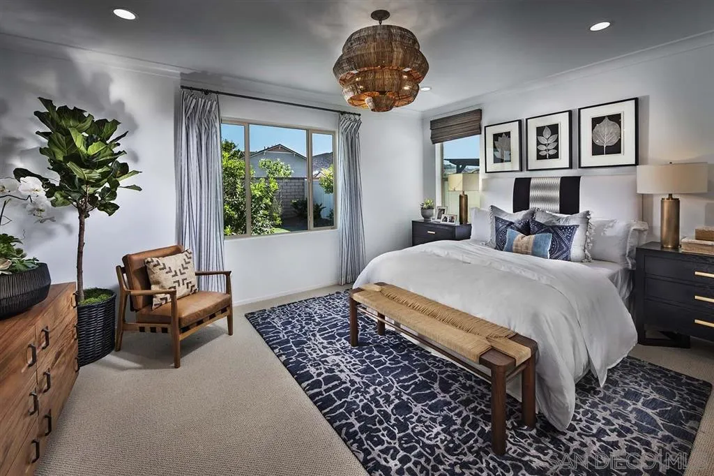 24384 Crooked Trail Menifee, CA 92584 - Photo 6 of 21 a spacious bedroom with a large bed and a chandelier