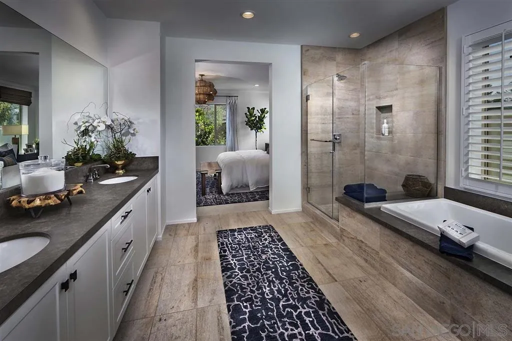 24384 Crooked Trail Menifee, CA 92584 - Photo 7 of 21 a spacious bathroom with a double vanity sink a large mirror and a shower