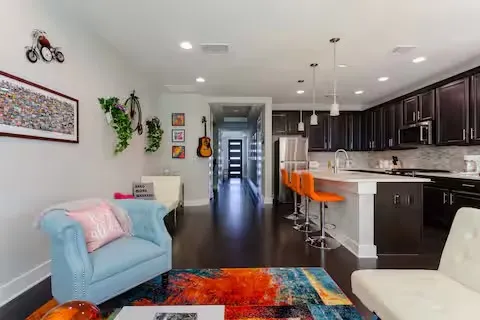 a living room with stainless steel appliances furniture or couch and a dining table