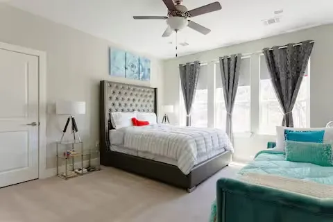 a bedroom with a bed couch and window