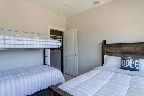 a bedroom with bed and wooden floor