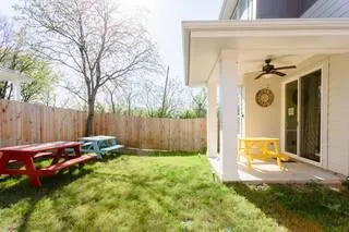 a backyard of a house with table and chairs