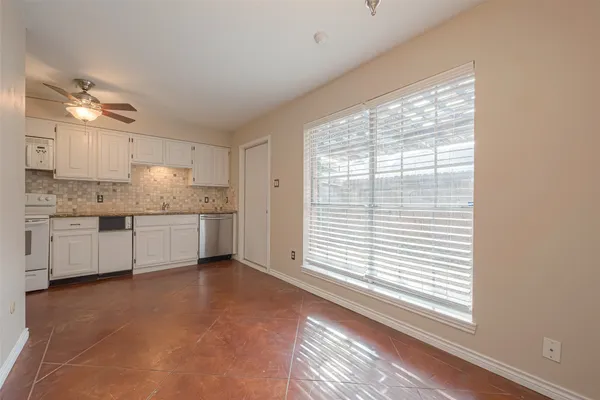 a kitchen with a window a sink and cabinets
