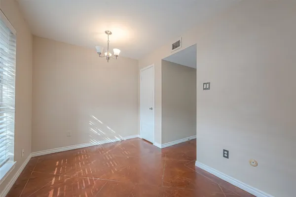an empty room with closet and a window