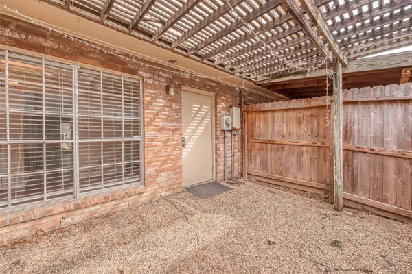 a view of backyard with wooden fence