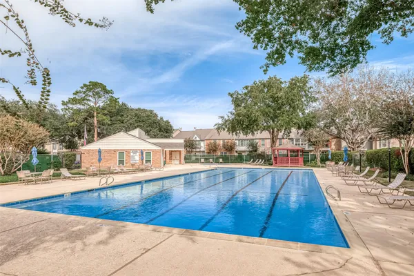a view of a swimming pool with a lounge chairs