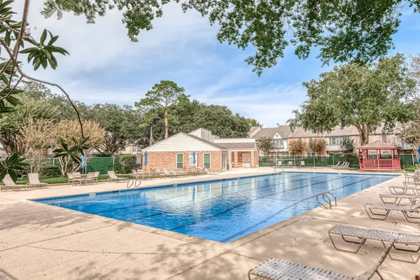 a view of a swimming pool with an outdoor seating
