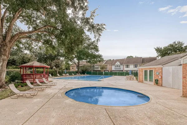 an outdoor space with pool and furniture