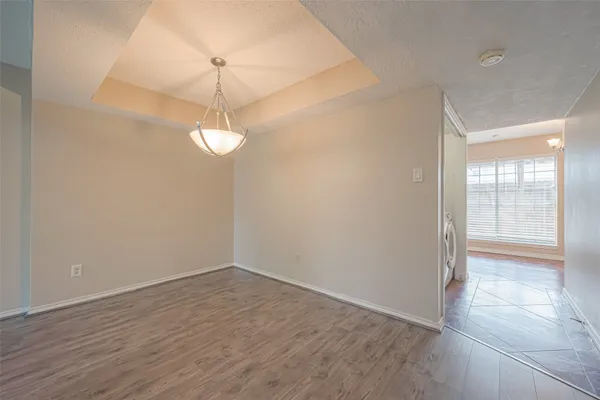 a view of a room with wooden floor and windows