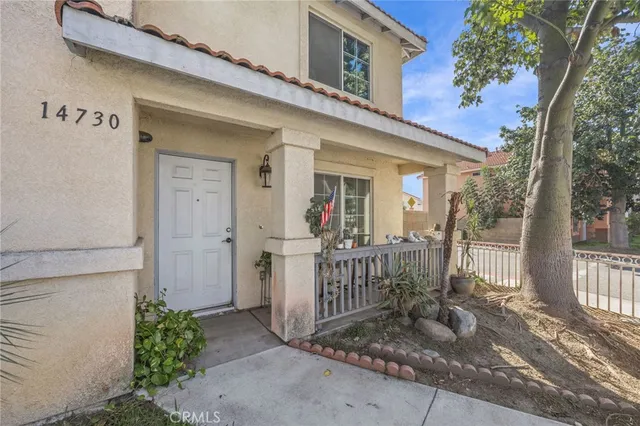 a view of a house with wooden fence next to a road