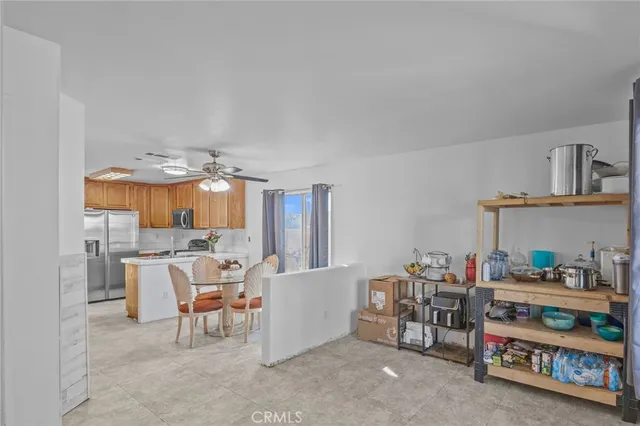 a living room with furniture and a dining table