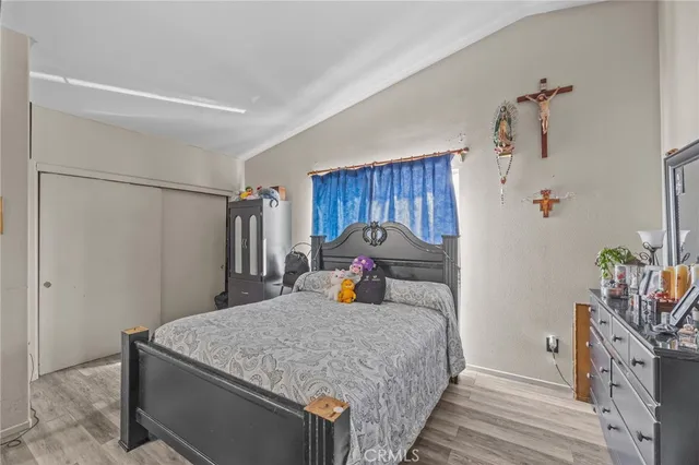 a bedroom with a bed and a dresser