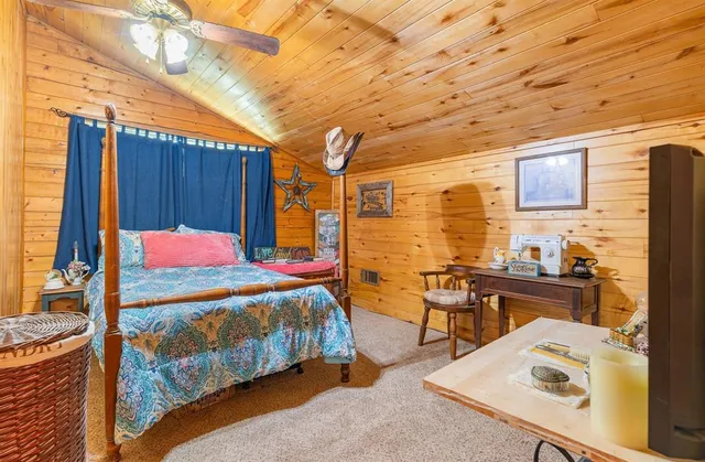 a bedroom with a bed and wooden cabinets