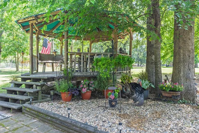 a view of an outdoor sitting area with furniture and umbrella