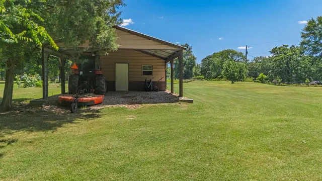 a view of a house with a backyard