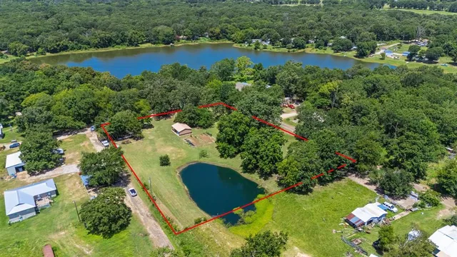an aerial view of residential house with outdoor space and swimming pool