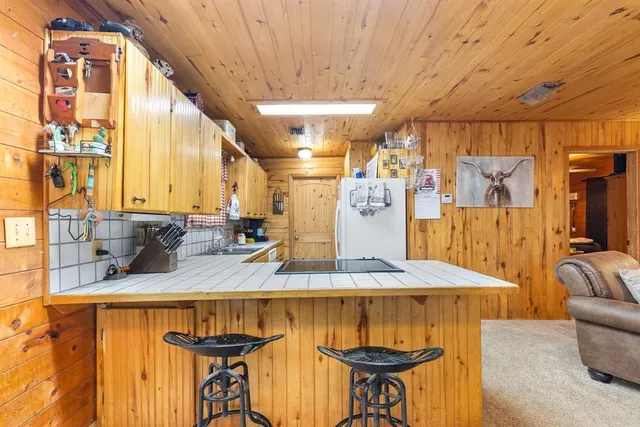 a kitchen with stainless steel appliances granite countertop a sink and a refrigerator