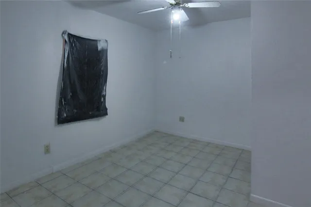 an empty room with a fan
