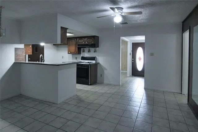 a kitchen with stainless steel appliances a stove sink and cabinets